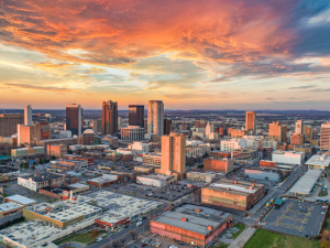 skyline photo of Birmingham Alabama with an orange sky over the city